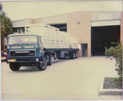 Old freight lorry in front of a warehouse