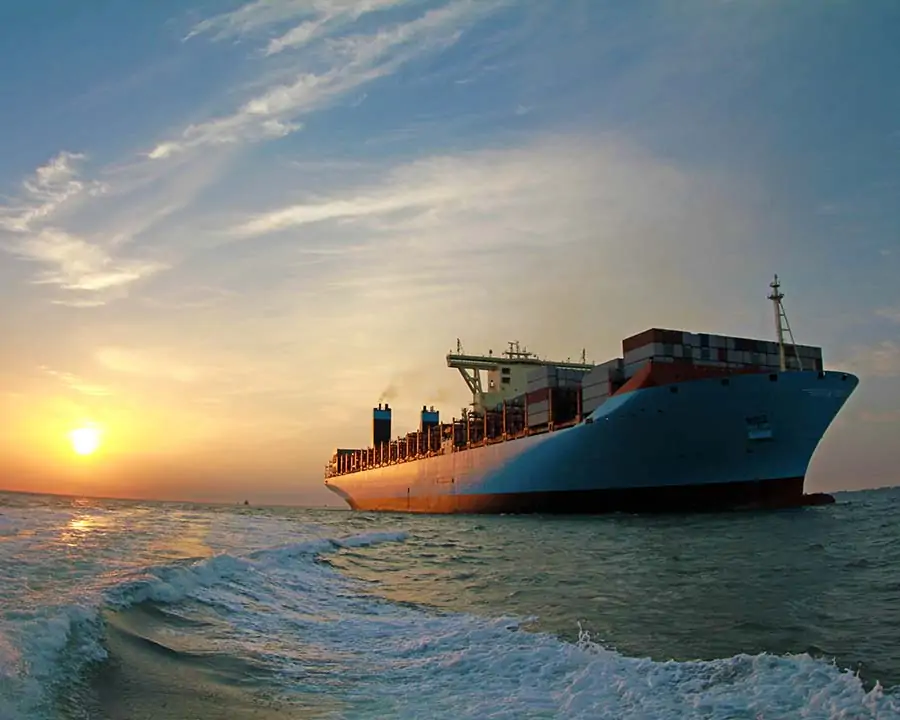large container ship at sea full of cargo to illustrate marine insurance